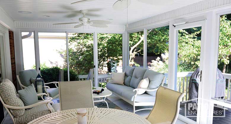 Screen room in white enclosing an existing covered porch.