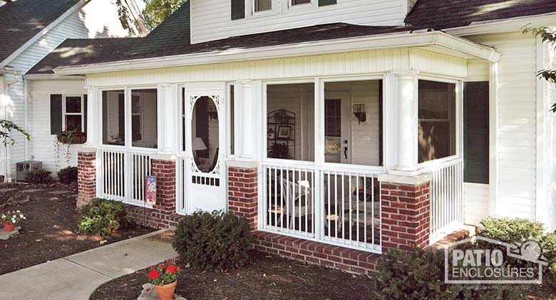 Screen room in white with picket railing system enclosing an existing front porch.