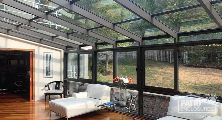 Screen rooms in white with picket railing systems enclosing existing covered porches.