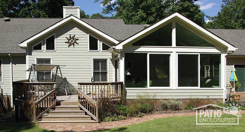 White four season room with aluminum frame and solid knee wall enclosing an existing screened porch.