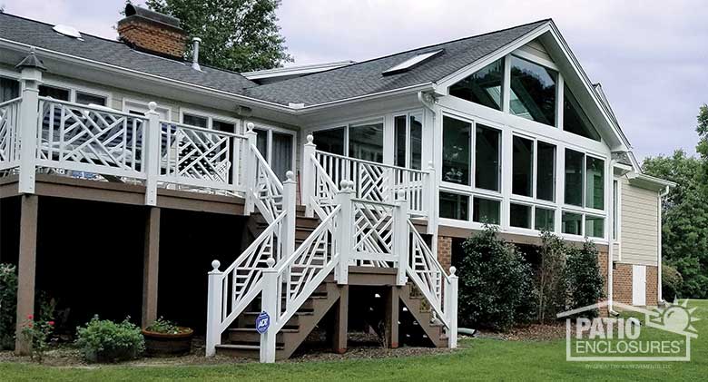 White four season sunroom with vinyl frame and glass knee wall enclosing an existing screened porch.