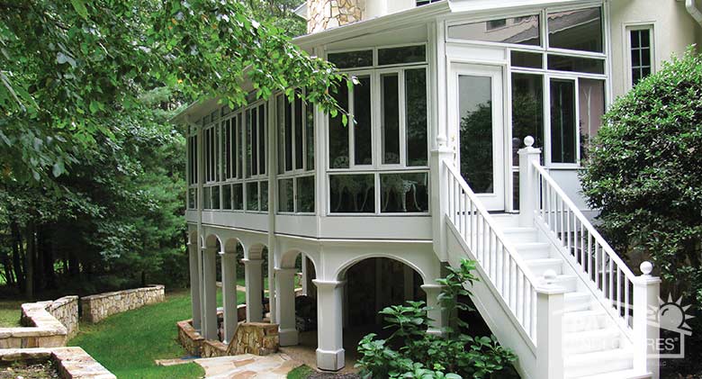 White four season sunroom on second level with aluminum frame, glass knee walls and transom.