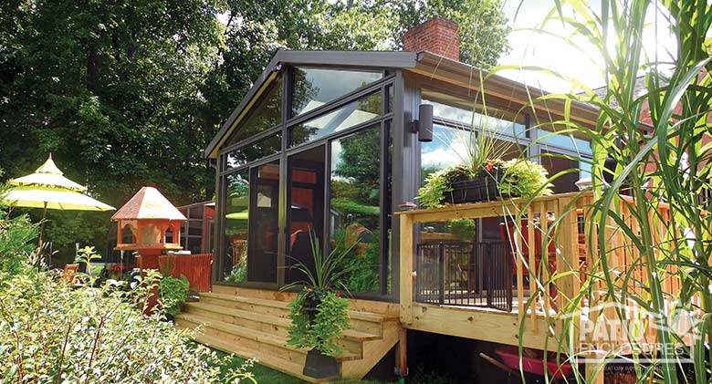 Bronze four season sunroom with aluminum frame, transoms and gable roof.