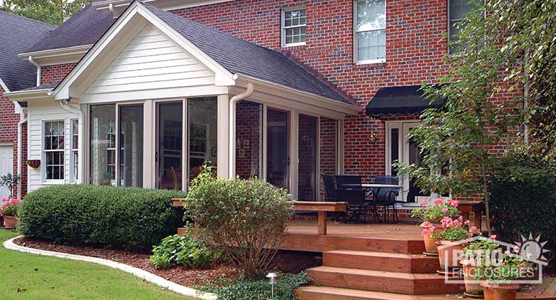 Sandstone four season room with aluminum frame and custom gable roof.