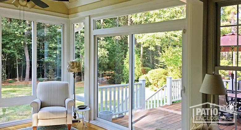 Interior view of four season sunroom with vinyl frame enclosing existing screen room.