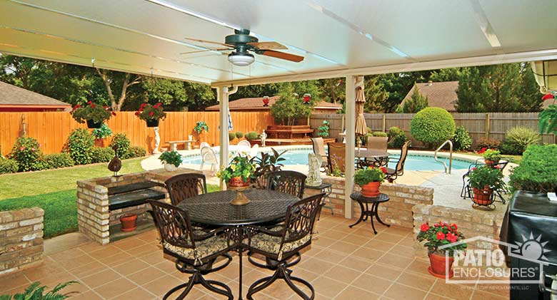 View of pool from under sandstone patio cover.