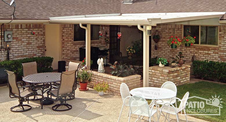 Sandstone patio cover with existing knee wall planters creates an outdoor “room.”