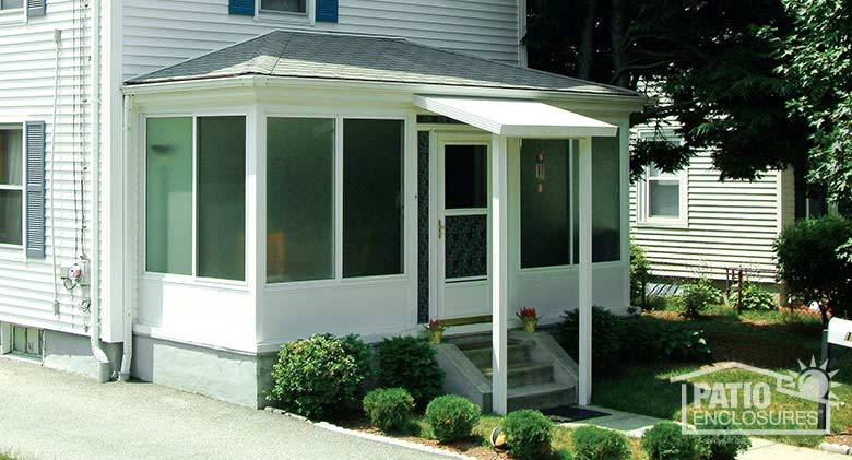 White porch cover attached to three-season sunroom.