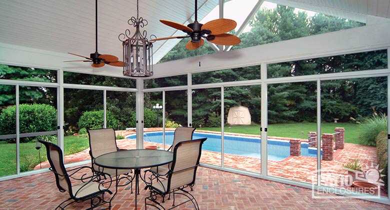 White screen room with transom enclosing existing covered patio with gable roof.