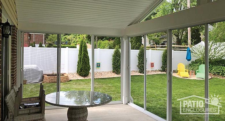 Interior view from screen room enclosing existing covered patio with gable roof.