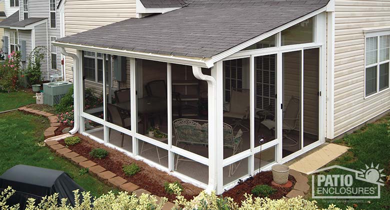 White screen room with knee wall and shingled, single-slope roof.