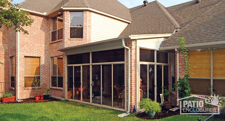 Sandstone screen room with transom enclosing existing covered patio.