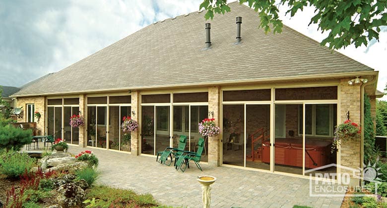 Sandstone screen room with transoms enclosing existing covered patio.