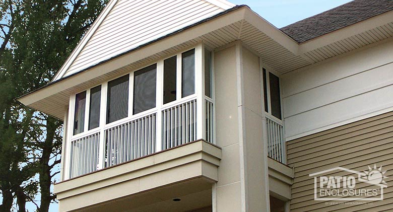 White screen room with picket railing system enclosing existing covered balcony.