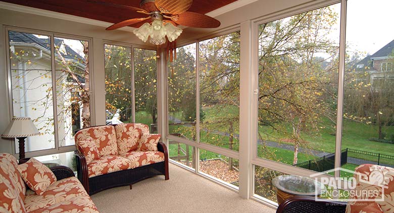 Sandstone screen room with knee wall enclosing existing covered porch.