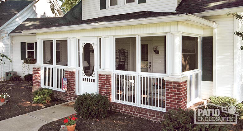 White screen room with picket railing system enclosing a covered front porch.