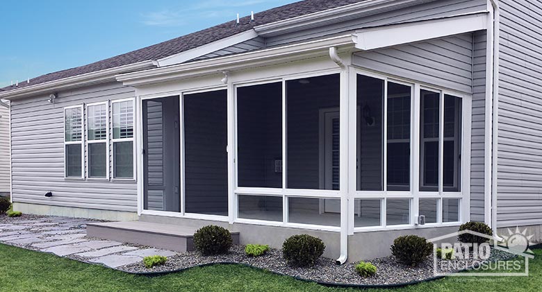 White screen room with knee wall and traditional wood roof.