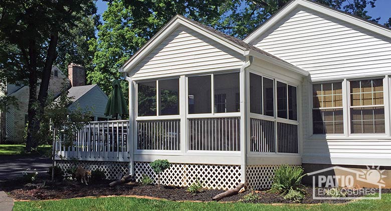 White screen room with custom, shingled wood roof and picket railing system.