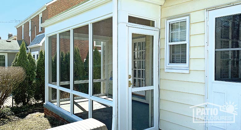 White screen room with knee wall enclosing existing covered patio.