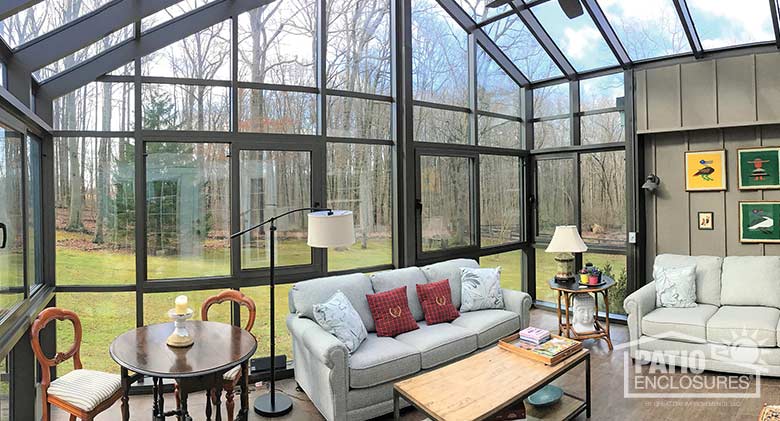 Bronze solarium with aluminum frame and gable roof.