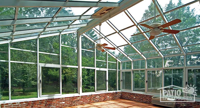 White solarium with aluminum frame and gable roof.