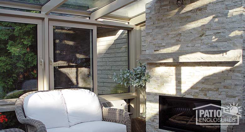 Sandstone solarium with aluminum frame and single-slope roof.