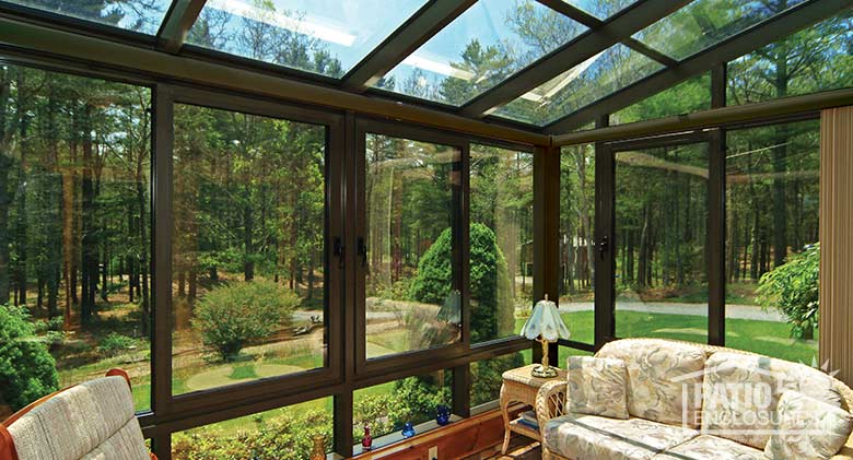 Bronze solarium with aluminum frame and single-slope roof.