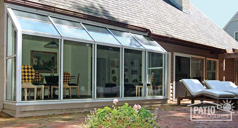 White solarium with aluminum frame and single-slope roof.