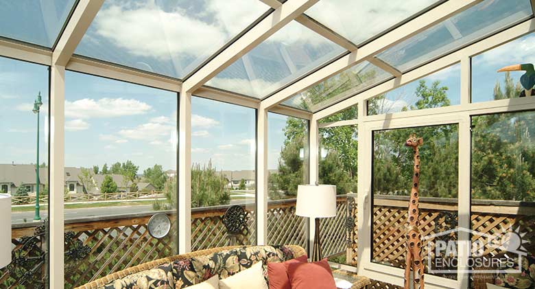 White solarium with aluminum frame and single-slope roof.