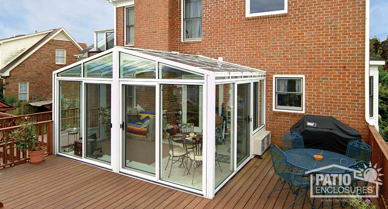 White solarium with aluminum frame and gable roof.