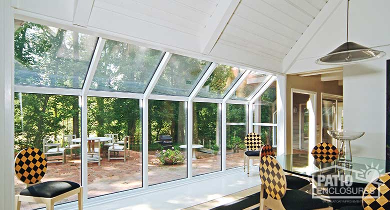 White solarium with aluminum frame and single-slope roof.