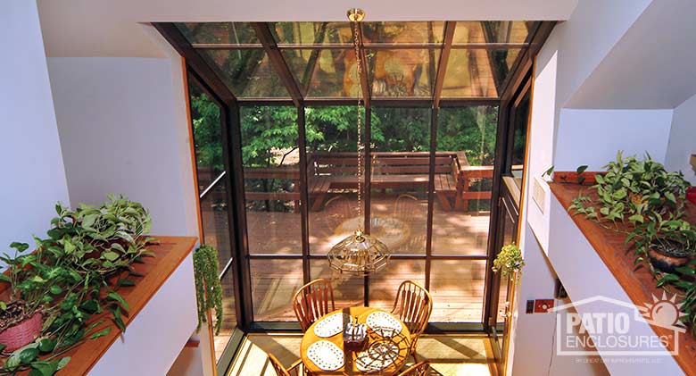 Bronze solarium with aluminum frame and single-slope roof.