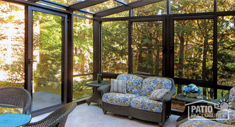 Bronze solarium with aluminum frame and single-slope roof.