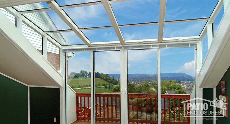 White solarium with aluminum frame and single-slope roof.