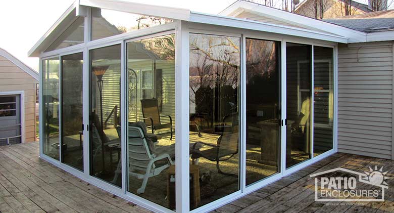 EasyRoom sunroom kit with white aluminum frame and gable roof.