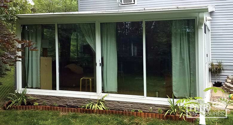 EasyRoom sunroom kit with white aluminum frame and single-slope roof.