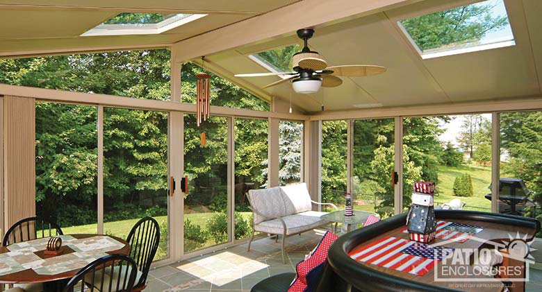 Sandstone three season sunroom with glass roof panels.