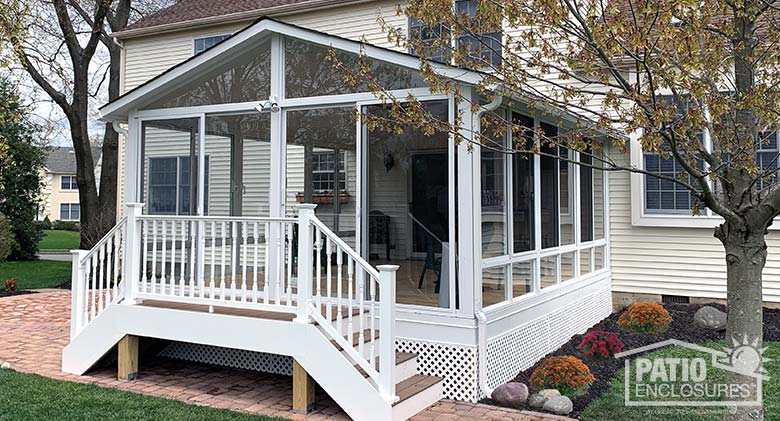 Elite three season room with glass knee walls, gable roof and dual stairs in front.