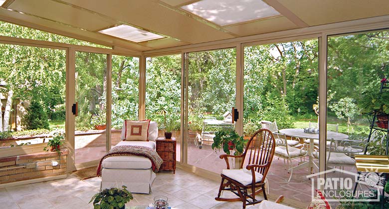 Sandstone three season sunroom with glass roof panels and single-slope roof.