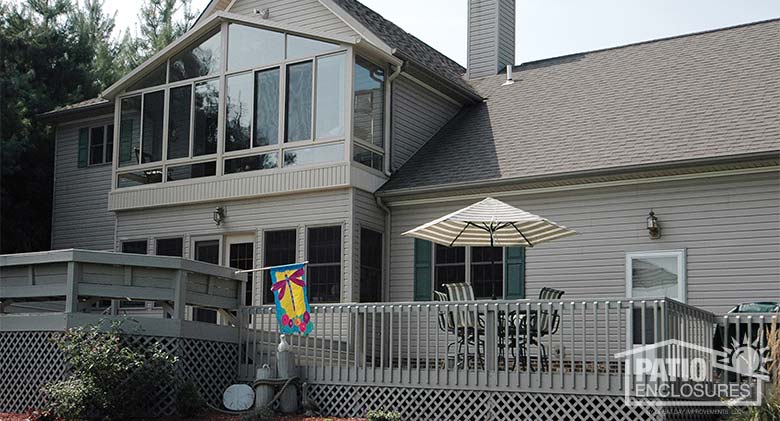 Second-story three season sunroom with insulated glass and gable roof.