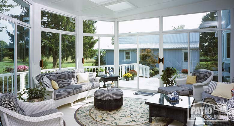 White three season room with transoms and glass roof panels.