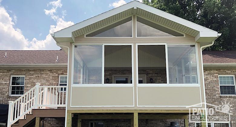 Three season sunroom mixing white and sandstone framing and knee wall for a unique look.