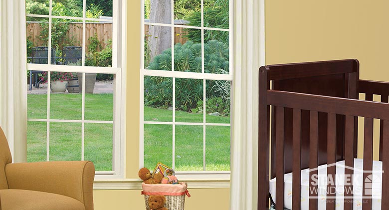 Two double-hung windows in white with interior colonial grids.