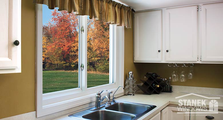 Two-lite sliding window in white is functional above a kitchen sink.