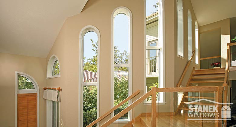 Custom-shaped windows add drama to this open staircase.