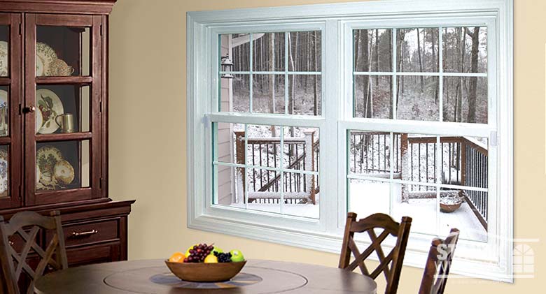 Two double-hung windows in white with interior colonial grids.