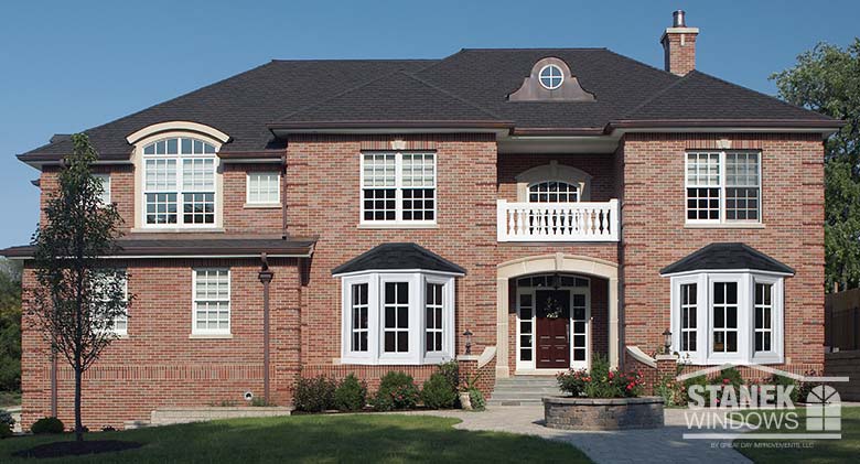 Three-lite bay windows in white with interior colonial grids add curb appeal to any home.