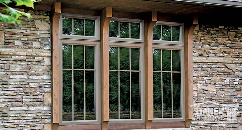 Casement windows with interior colonial grids and custom wood trim.