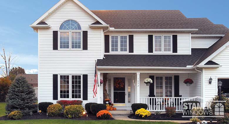 Colonial grids in casement windows and half-circle window add charm to this home.