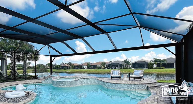A pool enclosure with a picture window for an unobstructed view of the neighborhood surrounding a free-form pool